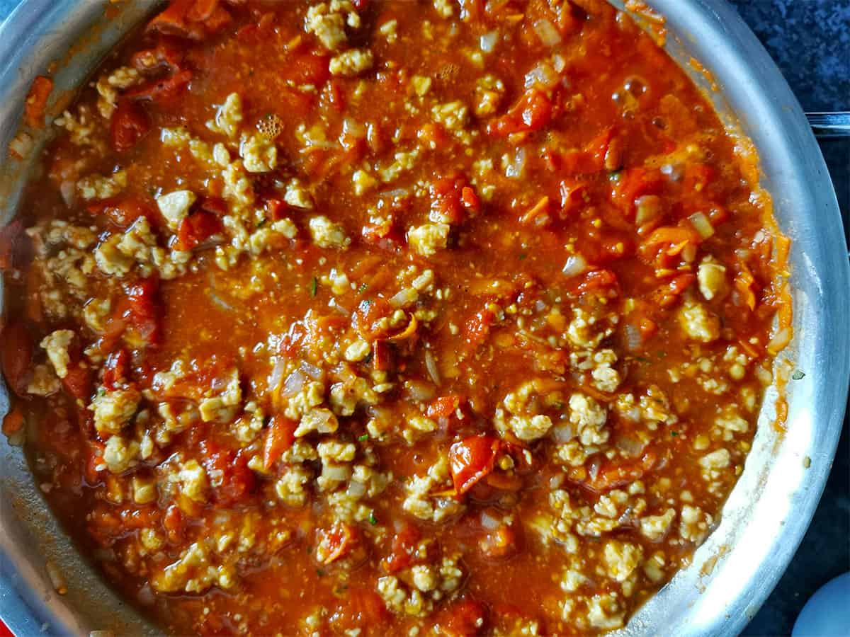 Bolognese sauce with crumbled tempeh in a pan.