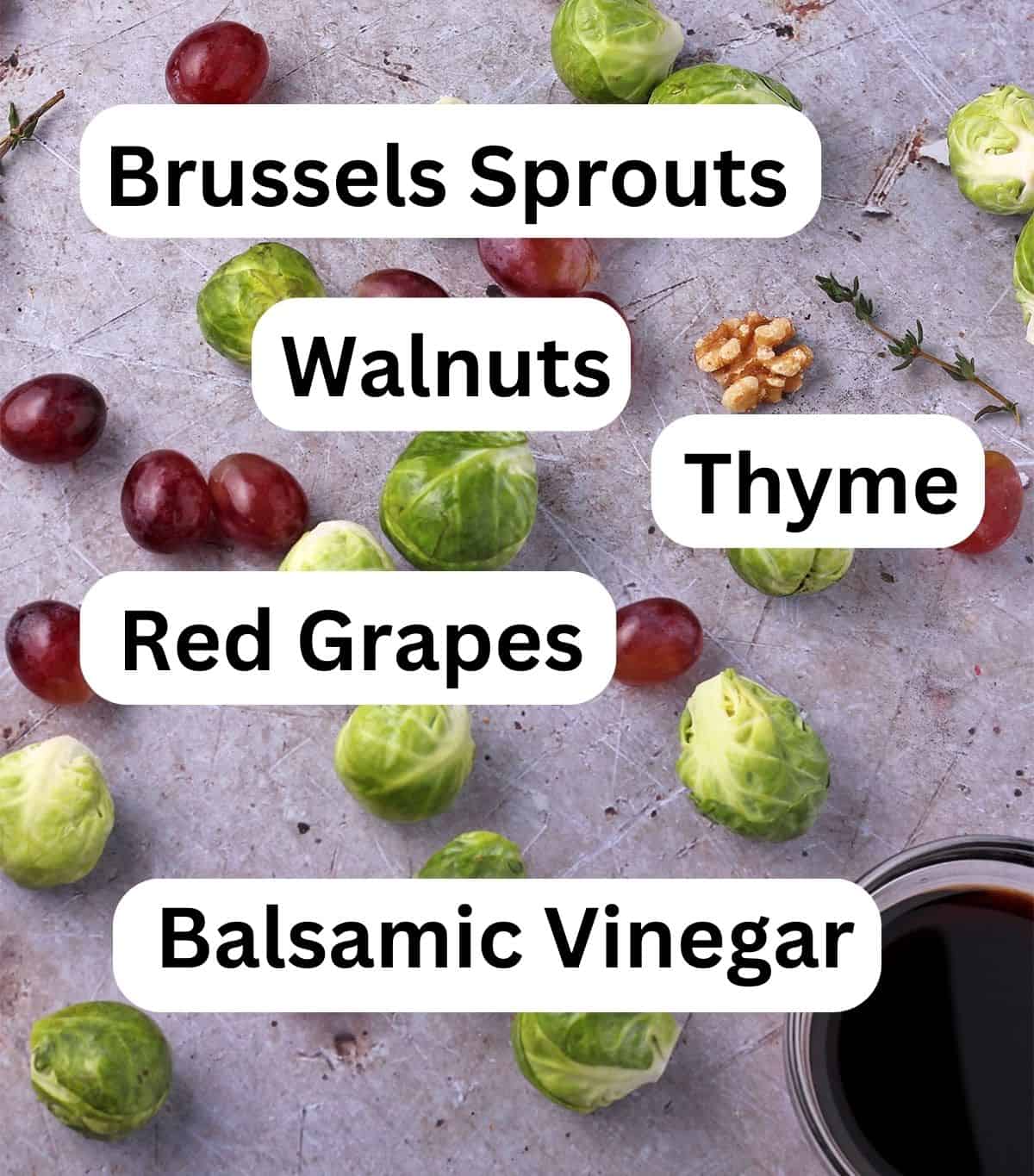 Brussels sprouts, red grapes, a dish of balsamic vinegar, a walnut, and thyme sprig with labels.