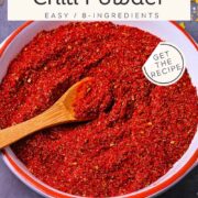 A picture of a dish of chili powder with a small wooden spoon with text overlay of recipe title and website.