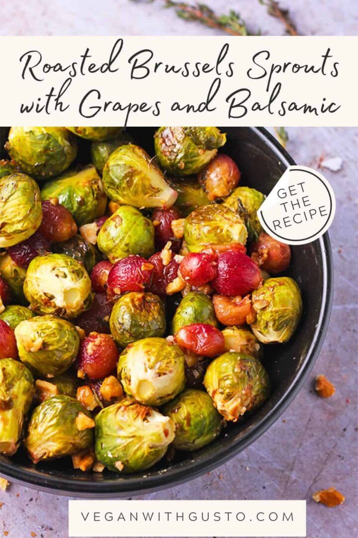 A black bowl filled with roasted Brussels sprouts and red grapes with chopped walnuts, thyme, and balsamic vinegar. Recipe title and website on picture.