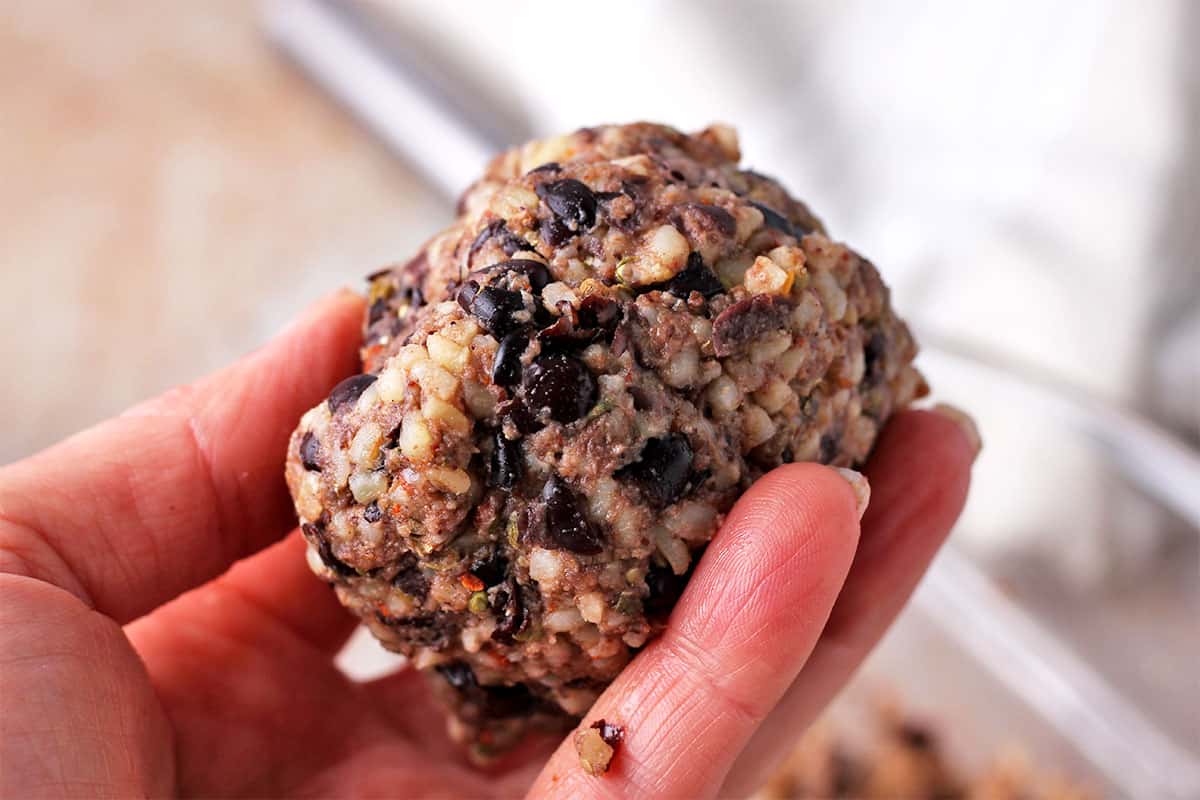 A ball of black beans, cooked bulgur, and breadcrumbs.