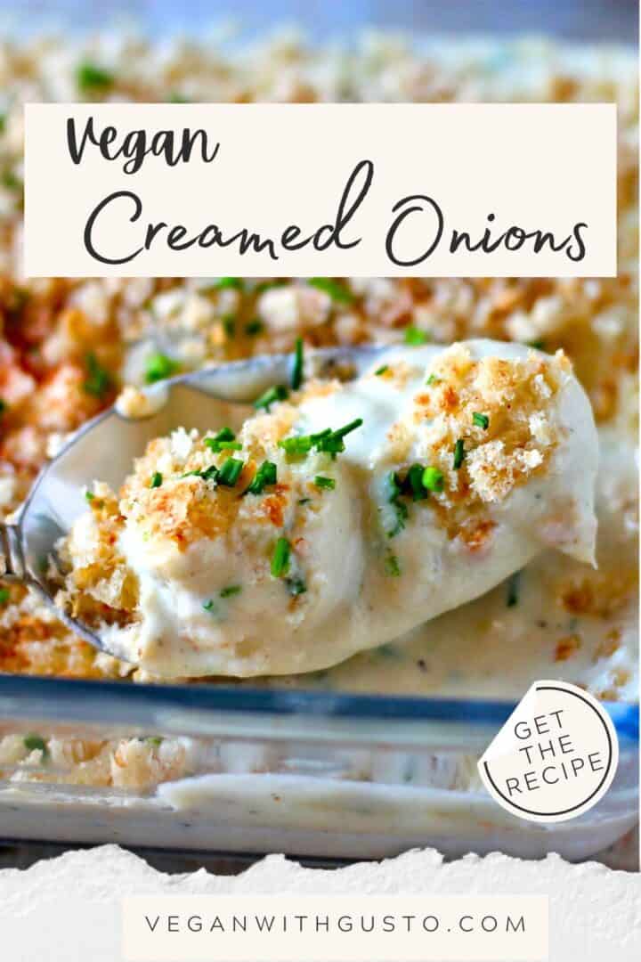 Creamed onions with chives and breadcrumbs are lifted from a casserole dish in a spoon.