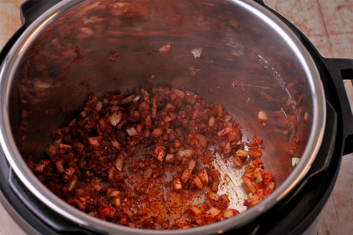 Onions, tomato paste, and spices cooked in the Instant Pot.