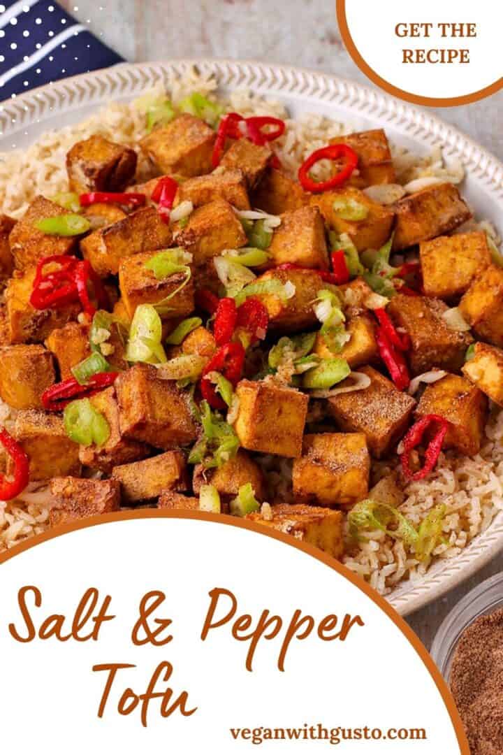 Salt and Pepper tofu over rice with onions and chili on top. Text overlay with recipe title on picture.