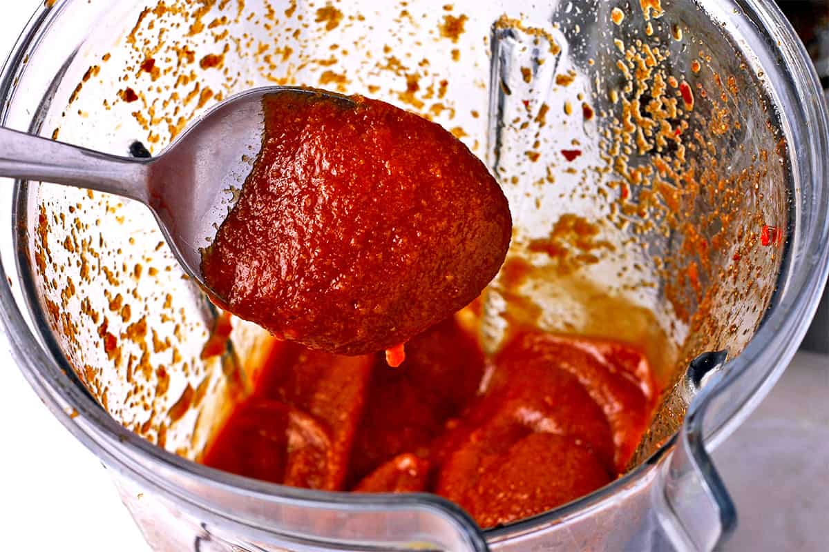 Marinara dipping sauce with a spoon in a blender.