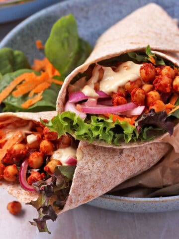 BBQ chickpea wraps with lettuce, dressing, and vegetables.