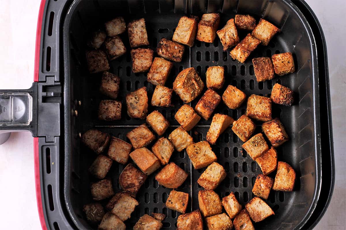 Croutons in the air fryer basket.
