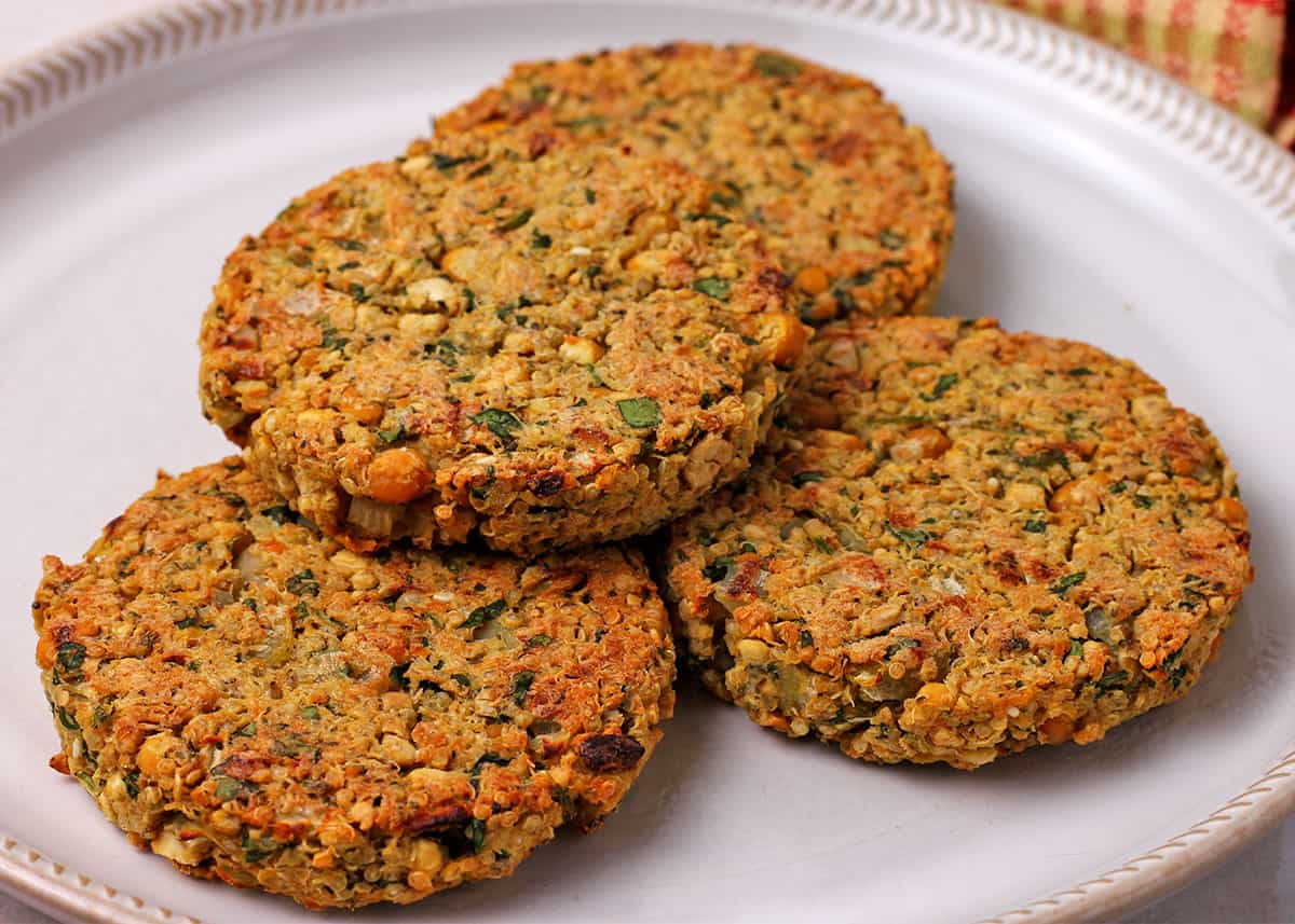 A plate of 4 baked chickpea patties.