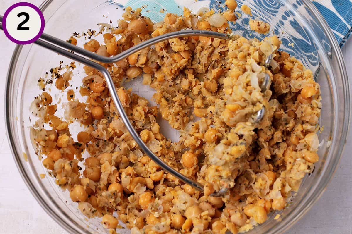 Chickpeas and spices mashed with a potato masher.