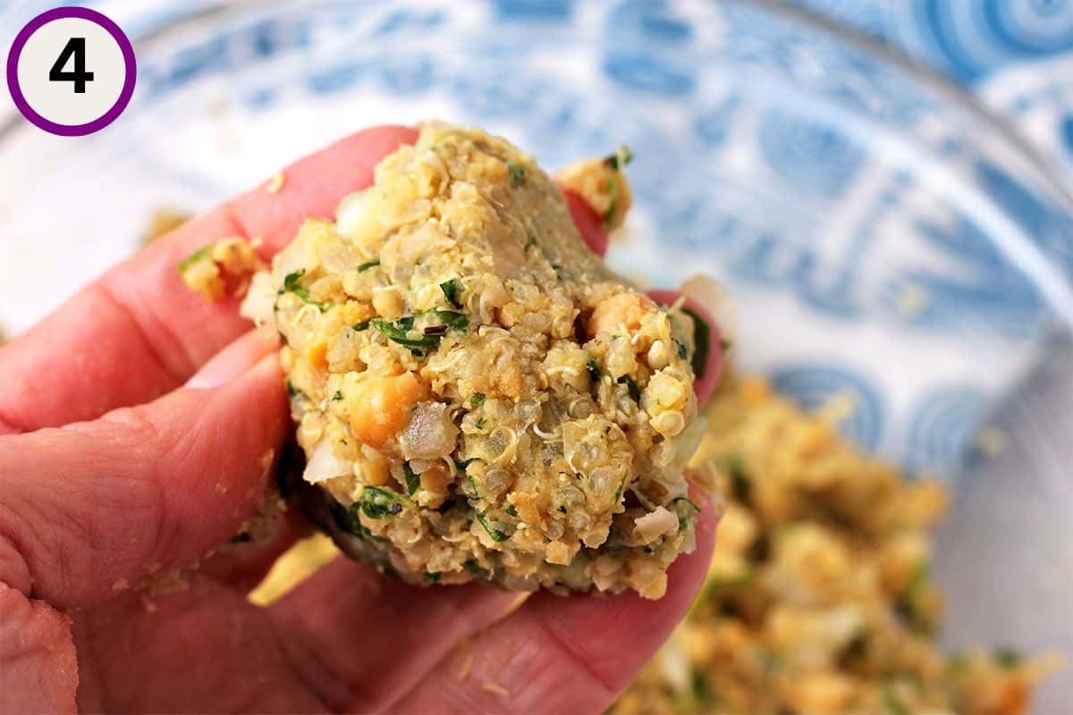 A ball of chickpea patty mixture is held over a bowl.