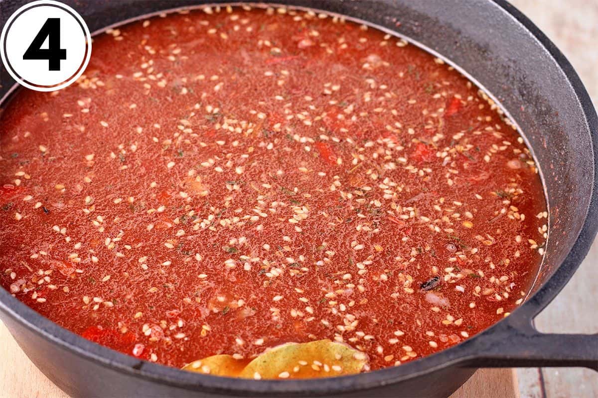 Quinoa and broth with tomato paste in a pot.