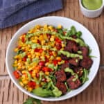 Spicy tofu bowls with corn salsa, avocado dressing and arugula.