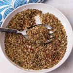 A bowl with za'atar seasoning and a spoon.