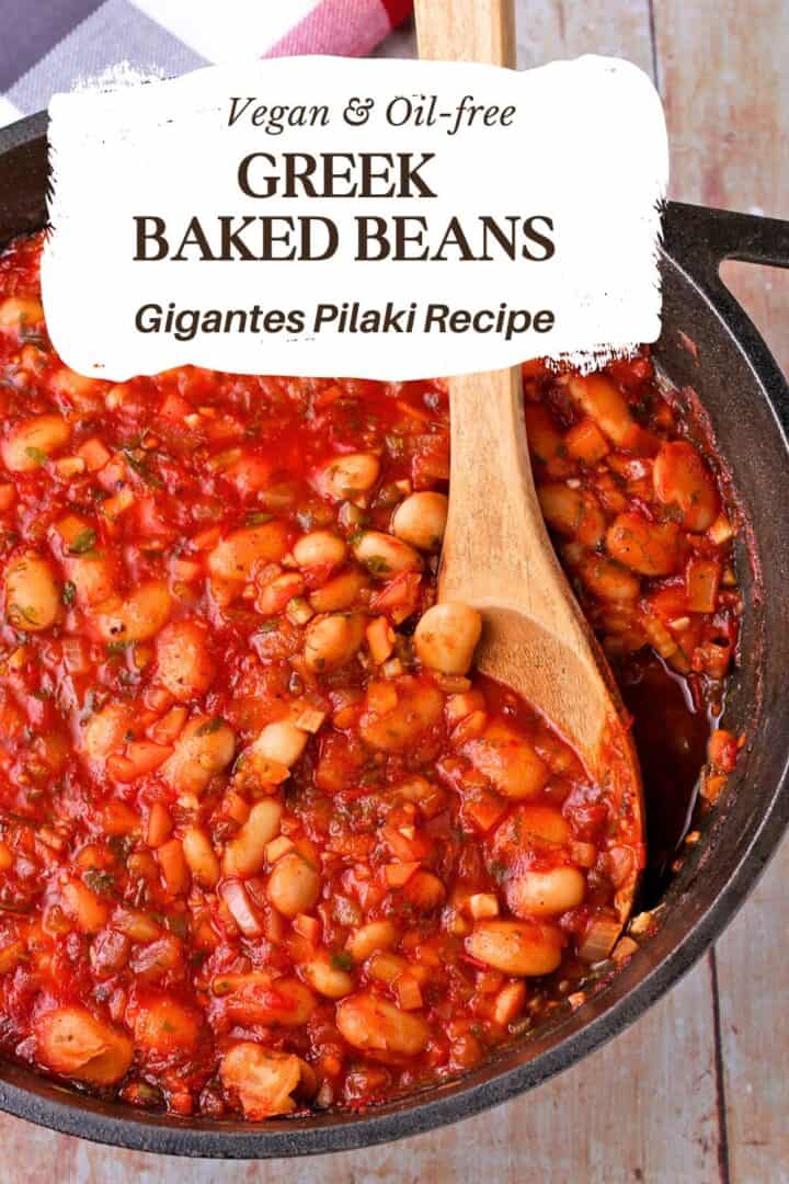 Greek baked beans in a cast iron pot with text overlay of recipe title on the photo.