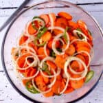 A bowl of Mexican pickled vegetables of carrots, onions, jalapenos, and oregano.