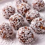 Coconut date balls on a plate.