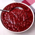 A dish of raspberry chipotle sauce with a spoon.