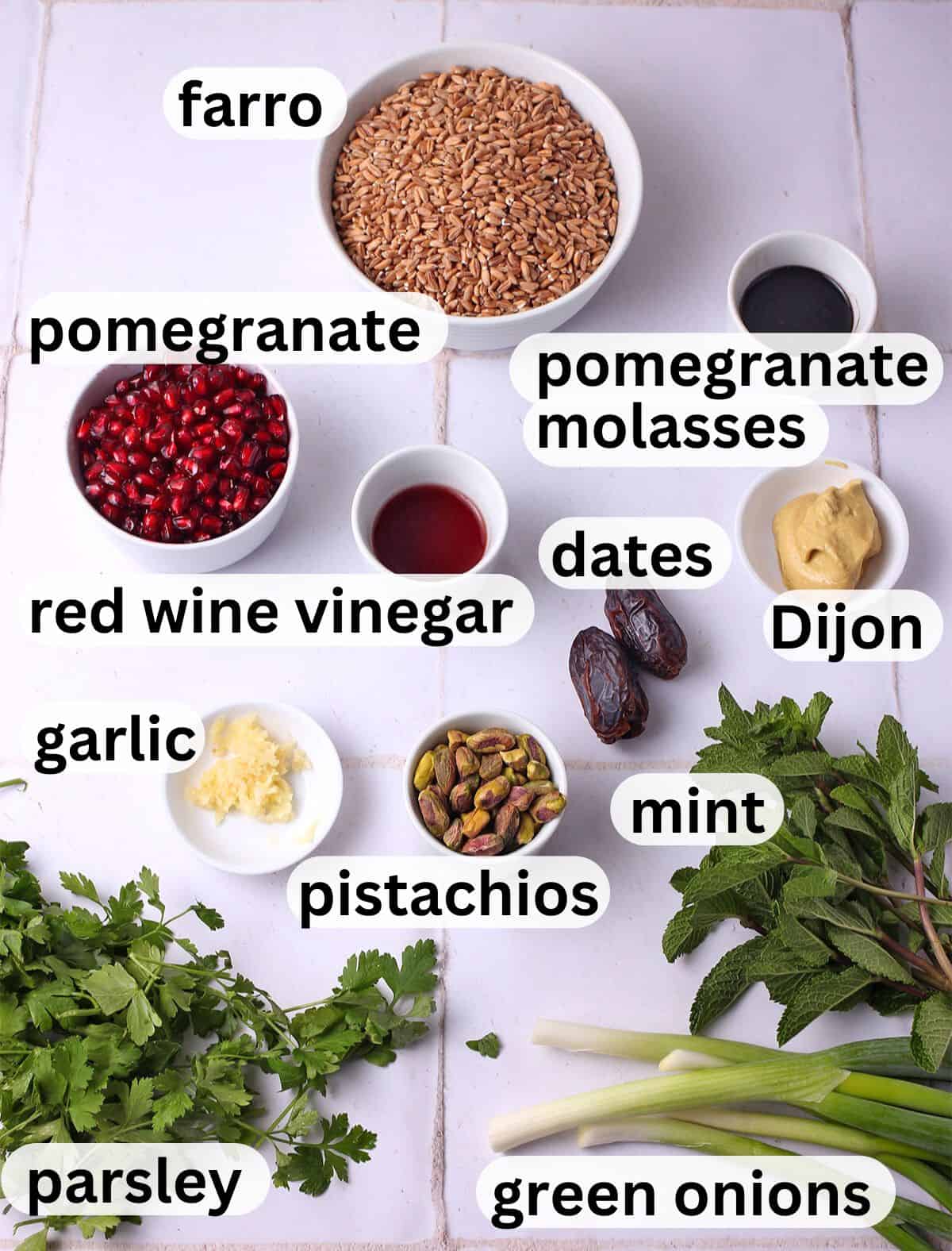 The ingredients for farro pomegranate salad with labels.