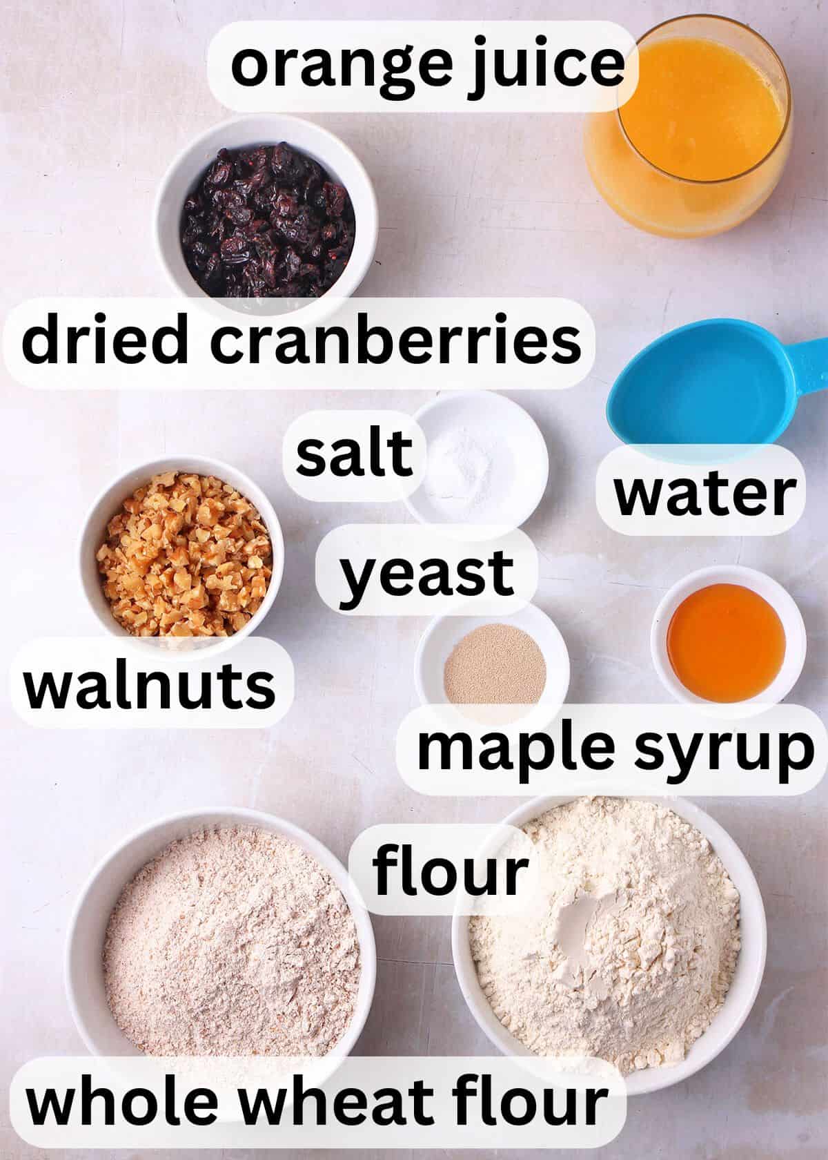 The ingredients for no-knead vegan cranberry walnut bread with labels.