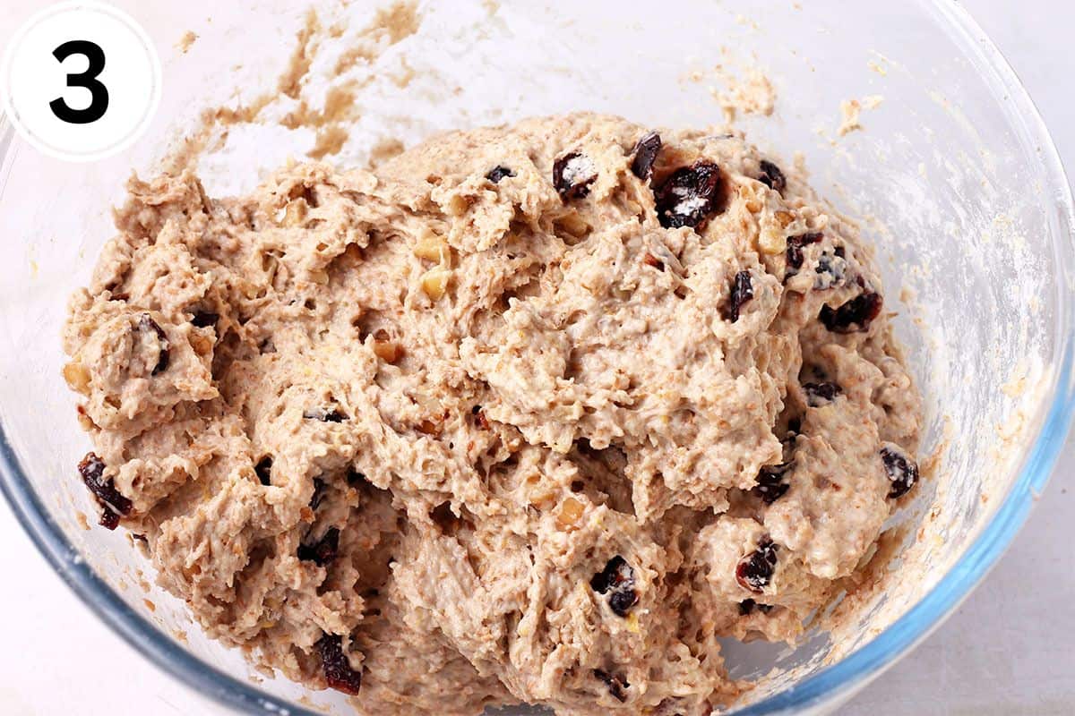Cranberry walnut bread dough is mixed in a bowl.