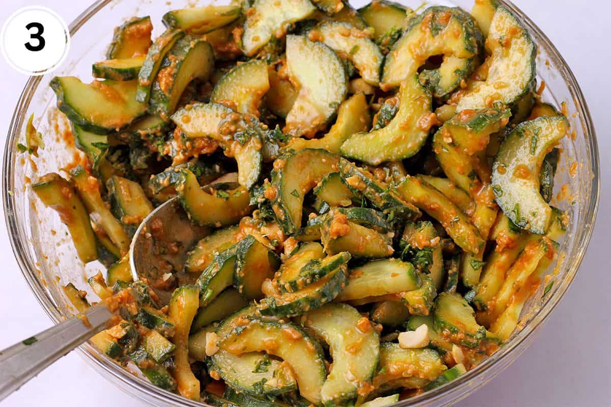 Sliced cucumbers are mixed with peanut dressing, cilantro, chopped peanuts, and lime zest.