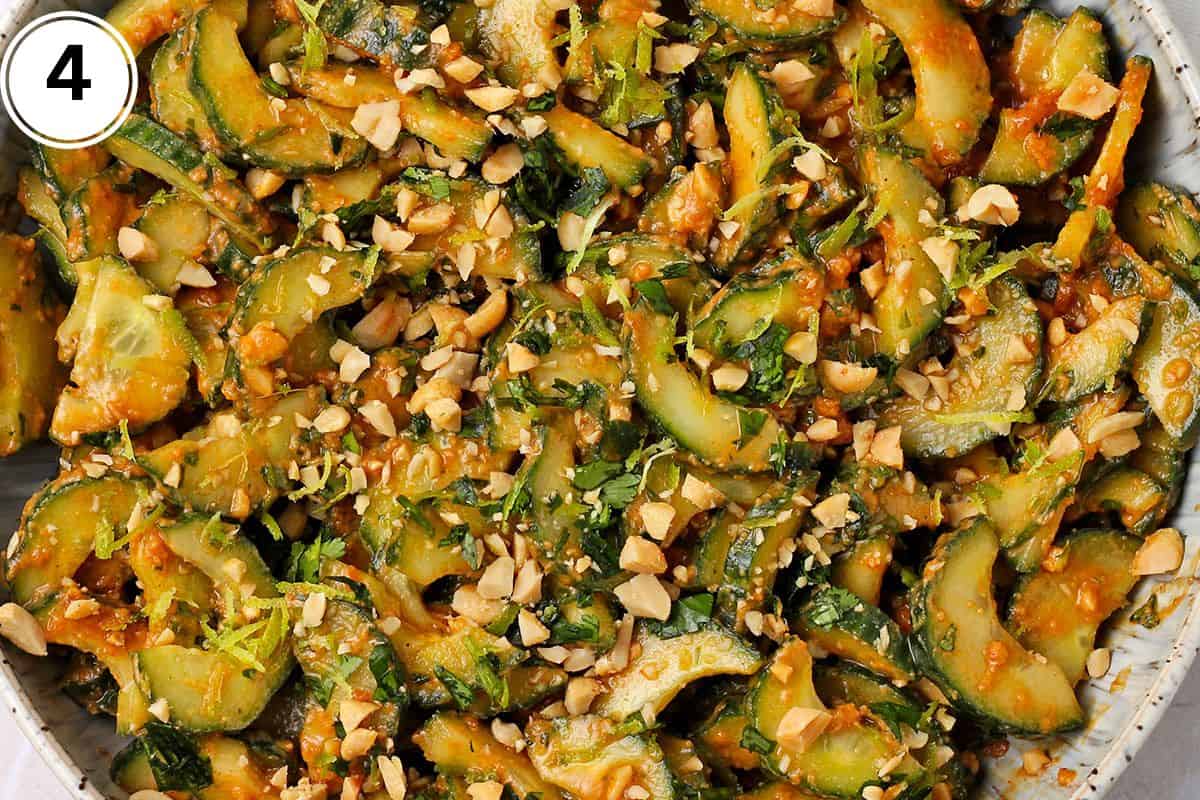 Cucumber and peanut dressing salad is topped with chopped peanuts, lime zest, and chopped cilantro.