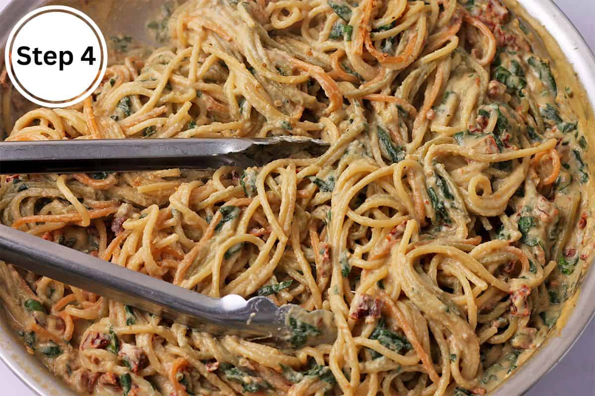 Spaghetti is mixed with vegan sundried tomato pasta sauce.