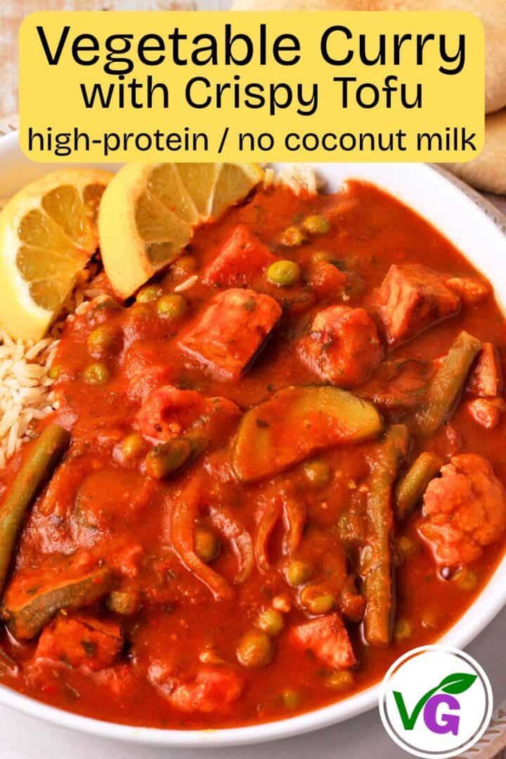 A bowl of tomato curry with vegetables and tofu.