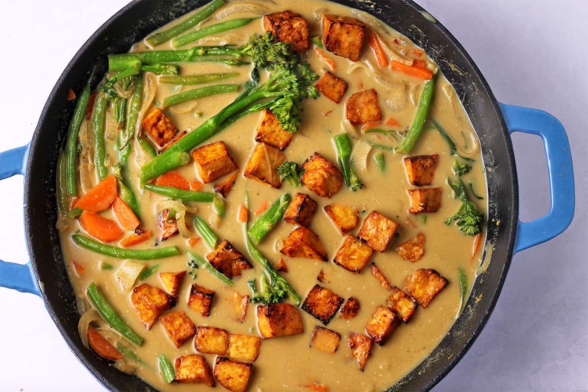 Massaman curry with tofu and vegetables is in a pot.