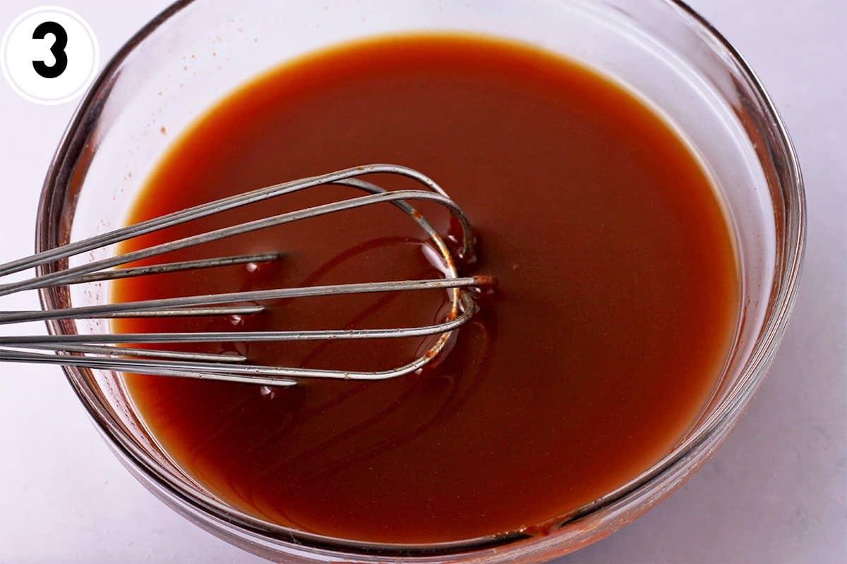 Gochujang sauce is whisked in a bowl.